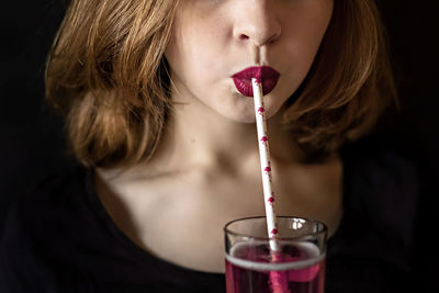 Close-up portrait of a woman drinking glass