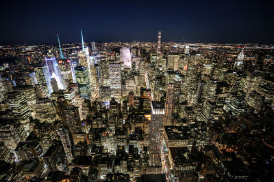 Aerial view of city lit up at night