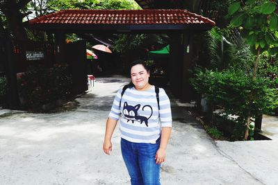 Portrait of smiling young woman standing outdoors