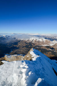 Aerial view of mountains against blue sky