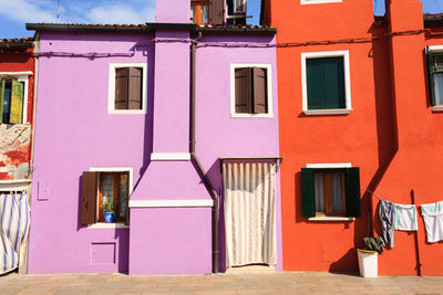 Multi colored houses on street by building