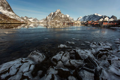 View of lake against mountain range during winter