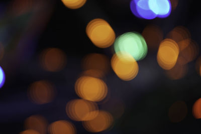 Defocused image of illuminated christmas lights at night