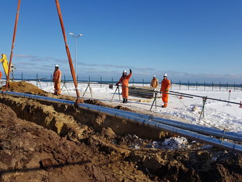 Workers working on construction site during winter