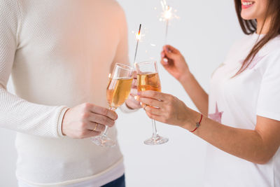 Midsection of a woman holding drink