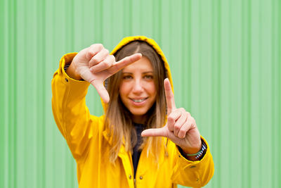 Portrait of woman making finger frame