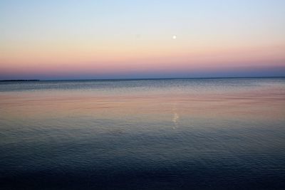 Scenic view of sea against clear sky during sunset