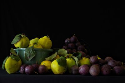 Close-up of apples and fruits against black background