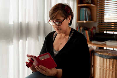 Young woman reading book at home