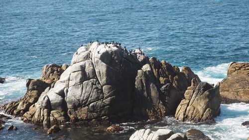 Panoramic view of rock formation in sea against clear sky