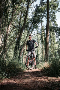 Man riding bicycle in forest