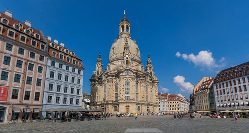 Buildings in city against blue sky