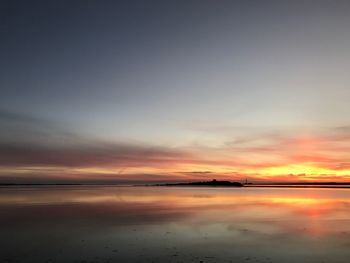 Scenic view of beach against sky during sunset