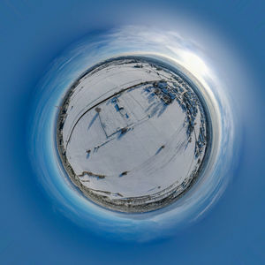 Digital composite image of blue sky seen through glass