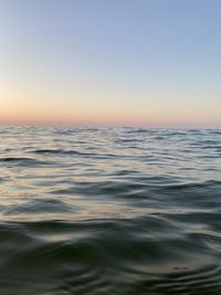 Scenic view of sea against clear sky during sunset
