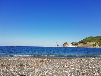 Scenic view of sea against clear blue sky
