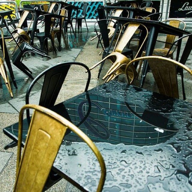 chair, table, empty, absence, seat, sunlight, restaurant, no people, high angle view, wood - material, in a row, day, metal, furniture, group of objects, still life, arrangement, indoors, shadow