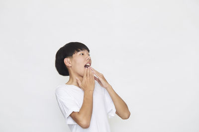 Portrait of a young woman against white background