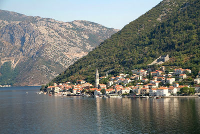 Scenic view of lake and mountains against clear sky