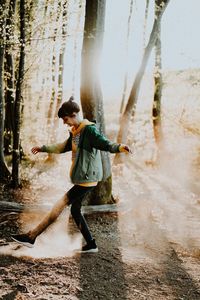 Full length side view of woman walking in water