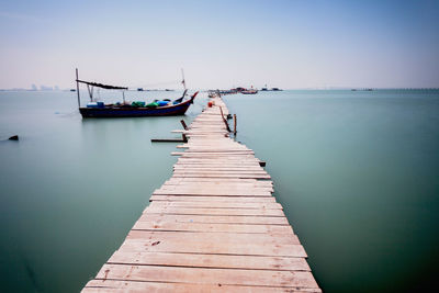 Pier over sea against clear sky