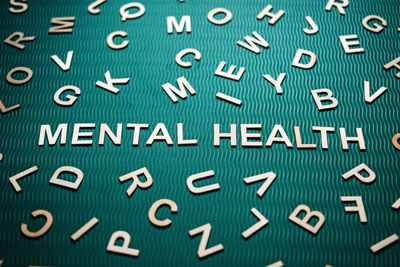 Mental health word from wooden letters. mental health text on green background with many other