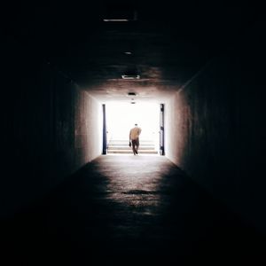 Woman walking in tunnel