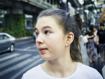 Girl looking away in city