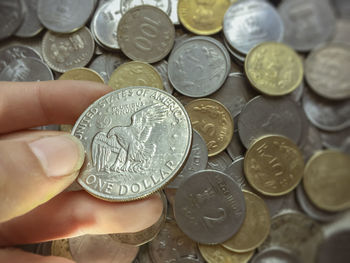 Close-up of hand holding coins