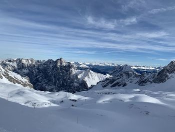 Scenic view of snow covered mountains against sky