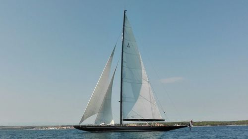 Boat sailing on sea against sky