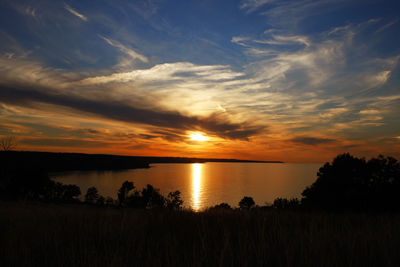 Scenic view of lake against sky during sunset