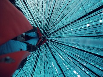 Close-up of man standing on metallic structure