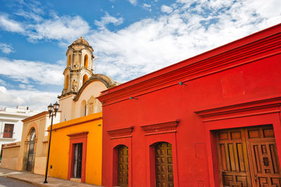 Low angle view of red building against sky