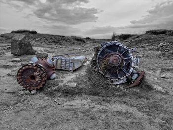 High angle view of abandoned vehicle on field against sky