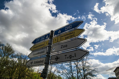 Low angle view of road sign against sky