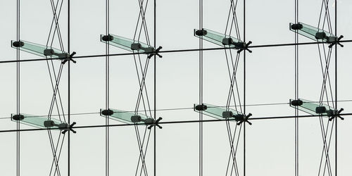 Low angle view of electricity pylon against clear sky