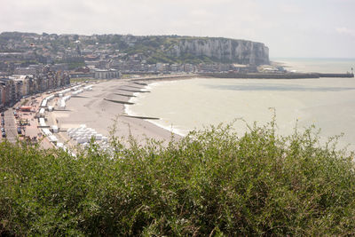 Scenic view of sea by city against sky