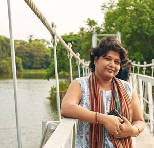 A bengali woman standing on the hanging bridge at rabindra sarovar lake, kolkata
