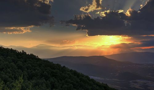 Scenic view of silhouette mountains against sky during sunset