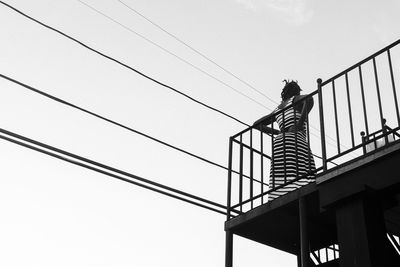 Low angle view of power lines against sky