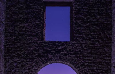 Low angle view of window against clear sky