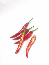 Close-up of red chili pepper against white background