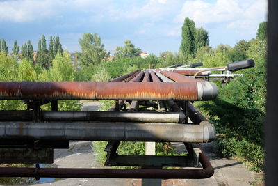 Old rusty pipelines against trees