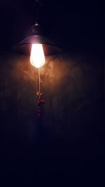 Illuminated lamp against sky