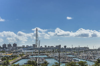 River amidst buildings in city against sky