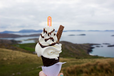 Close-up of hand holding ice cream cone