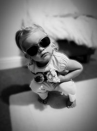 Portrait of cute girl sitting in sunglasses