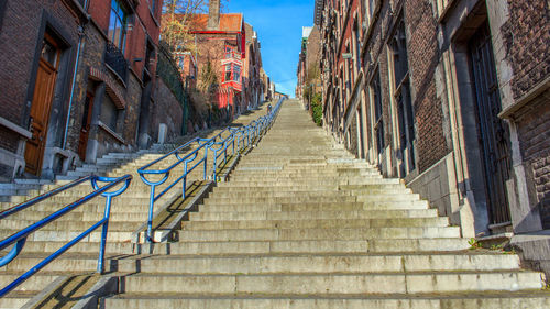 Staircase amidst buildings against sky