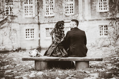 Couple sitting outside building